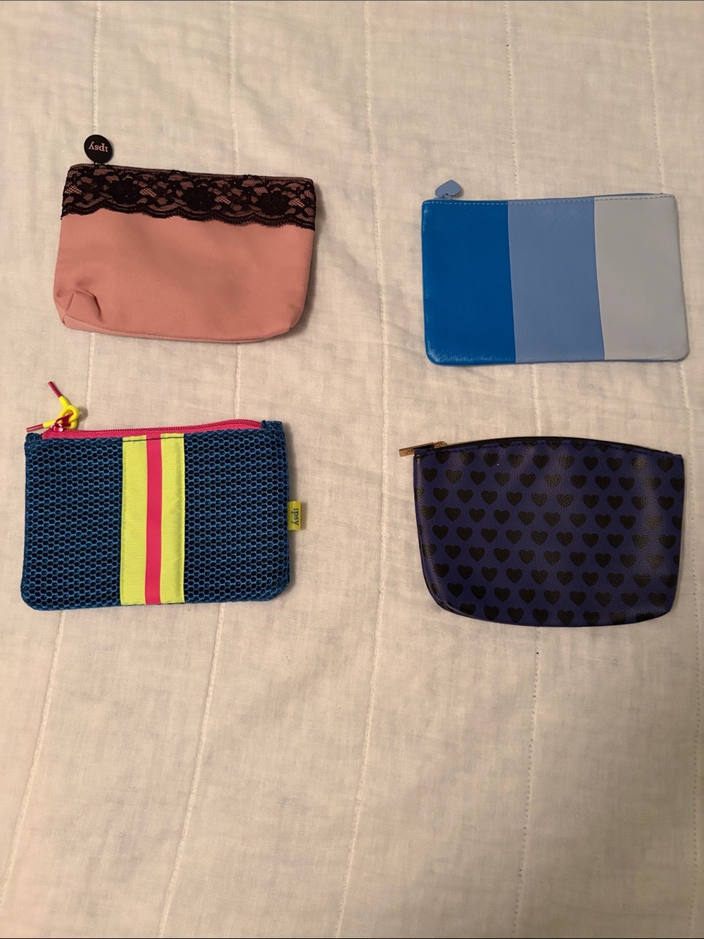 Bundle of four cosmetic bags